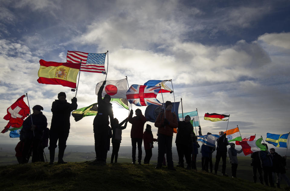 Residents of Lockerbie and others affected by the bombing climb Burnswark Hill, above the town of Lockerbie, in Dumfries and Galloway with 21 flags, representing the 21 nationalities of the victims, for the Walk for Peace event to commemorate the 30th anniversary of the air disaster. (Photo by Jane Barlow/PA Images via Getty Images)