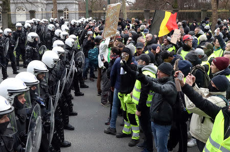 Demonstrators face riot police during the "yellow vests" protest against higher fuel prices, in Brussels, Belgium, December 8, 2018. REUTERS/Yves Herman