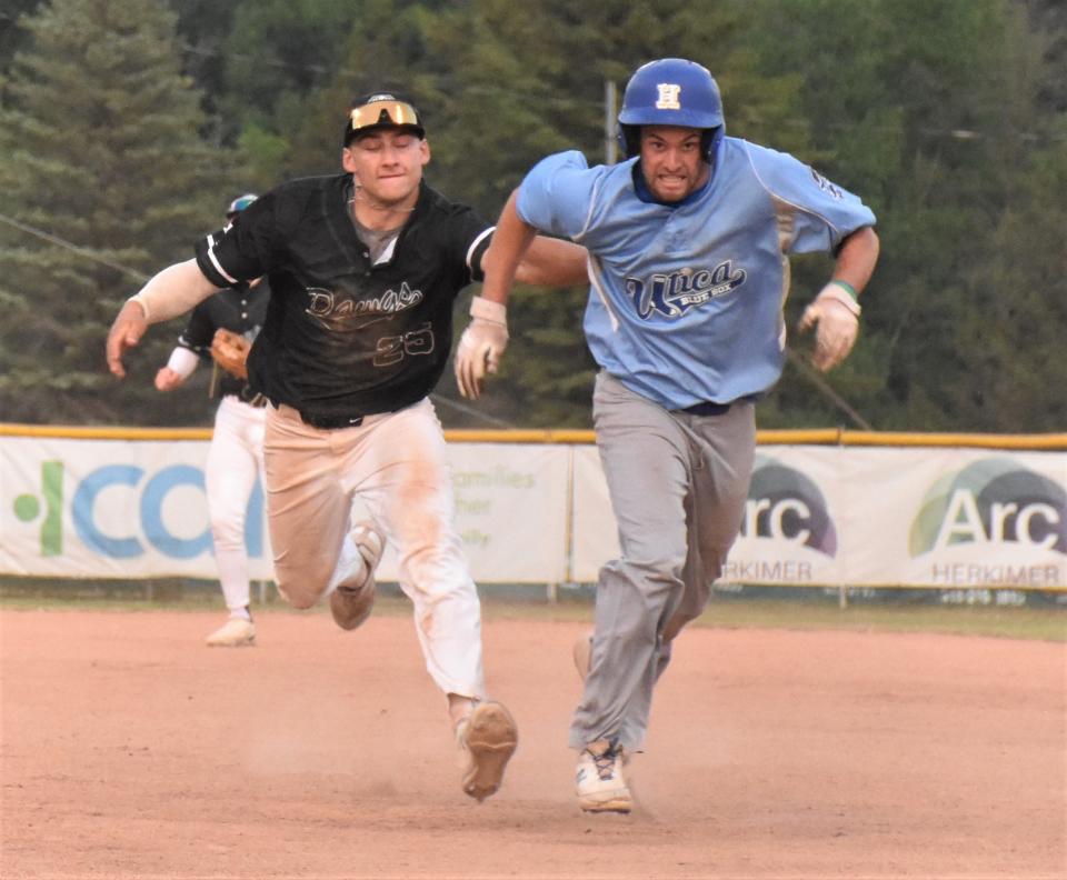 Mohawk Valley DiamondDawgs shortstop Justin Hackett (left) tags out Utica's Taylor Kaufman at the end of a rundown during the teams' Thursday PGCBL opener at Veterans Memorial Park.