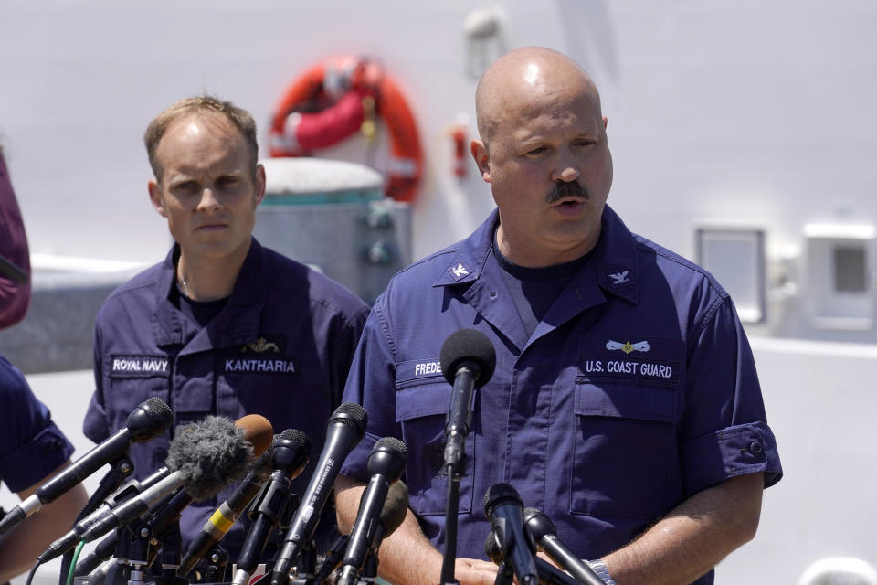 U.S. Coast Guard Capt. Jamie Frederick, right, faces reporters as Royal Navy Lt Cdr Rich Kantharia, left, looks on during a news conference, Wednesday, June 21, 2023, at Coast Guard Base Boston, in Boston. The U.S. Coast Guard says sounds and banging noises have been heard from the search area for Titanic submersible. (AP Photo/Steven Senne)
