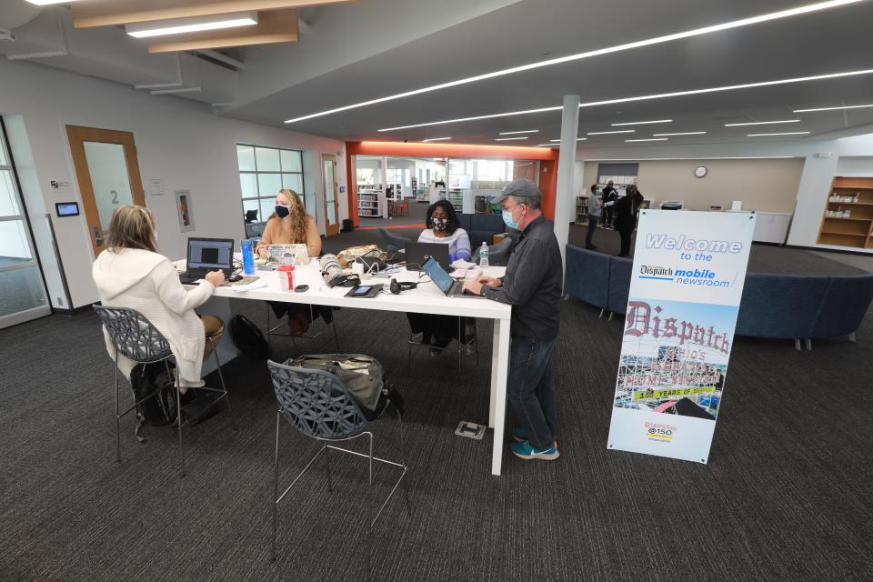 Columbus Dispatch staff members work in the Mobile Newsroom at the Karl Road Branch of the Columbus Metropolitan Library. From left are reporters Holly Zachariah, Sheridan Hendrix and Micah Walker and photographer Doral Chenoweth.