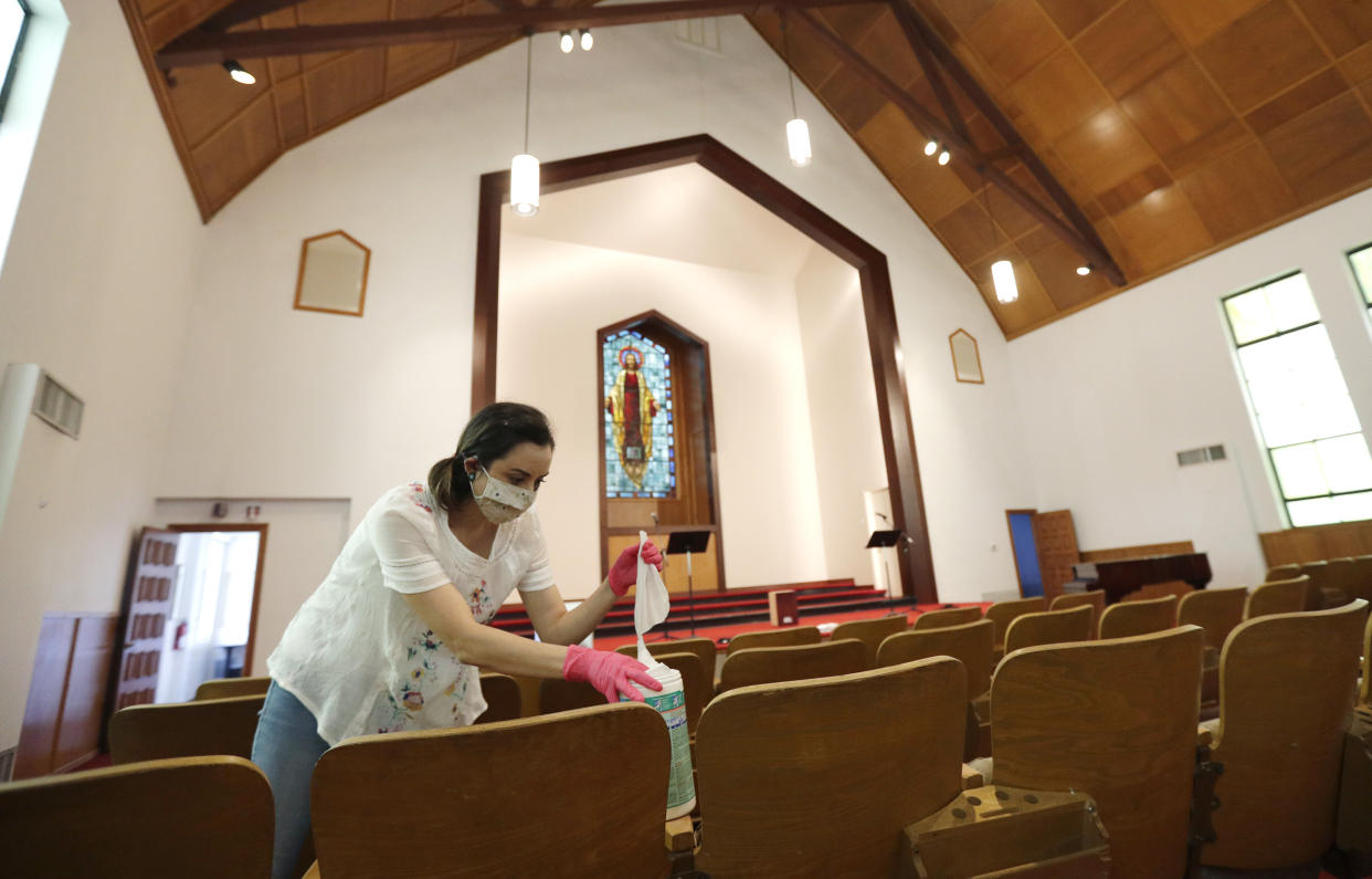 Hannah Contreras helps to clean, sanitize and prepare Alamo Heights Baptist Church for services this Sunday, in San Antonio, May 6. In a new HuffPost/YouGov poll, support for state stay-at-home orders has fallen from its peak, but remains high.  (AP Photo/Eric Gay) (Photo: ASSOCIATED PRESS)