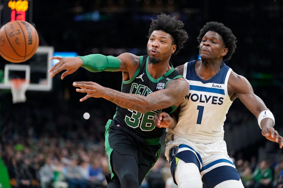Timberwolves forward Anthony Edwards (1) has drawn comparisons to NBA Defensive Player of the Year Marcus Smart (36).