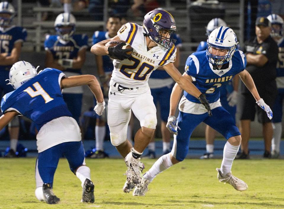 Orestimba’s Drew Felber (20) runs the ball after a catch during the Southern League game with Ripon Christian in Ripon, Calif., Friday, Sept. 22, 2023.