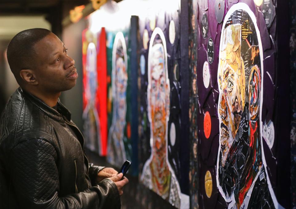 Karon Boston of Akron looks at artwork of LeBron James as he tours House Three Thirty on its official opening day on Thursday.