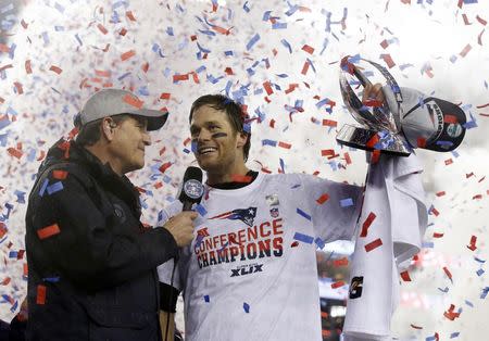 New England Patriots quarterback Tom Brady holds up the Lamar Hunt Trophy as he is interviewed after the AFC Championship Game against the Indianapolis Colts. REUTERS/David Butler II-USA TODAY Sports