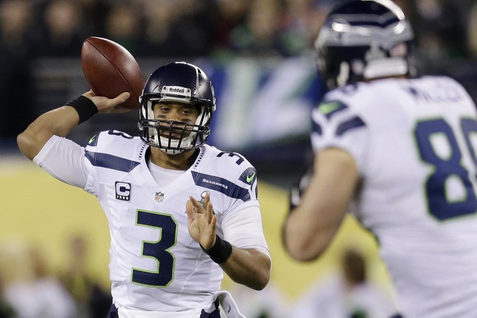 Seattle Seahawks' Russell Wilson looks to pass against the Denver Broncos during the first half of the NFL Super Bowl XLVIII football game Sunday, Feb. 2, 2014, in East Rutherford, N.J. (AP Photo/Julio Cortez)