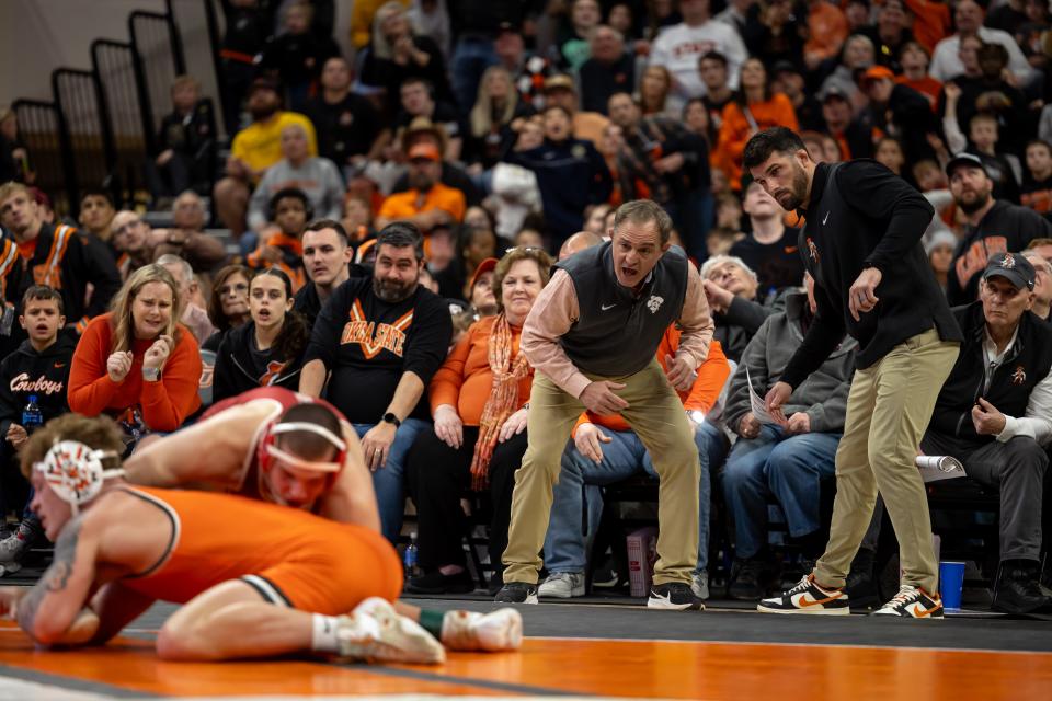 Oklahoma State coach John Smith looks on from the sideline as OSU 174-pounder Brayden Thompson wrestles OU's Tate Picklo during Sunday's dual at Gallagher-Iba Arena in Stillwater.