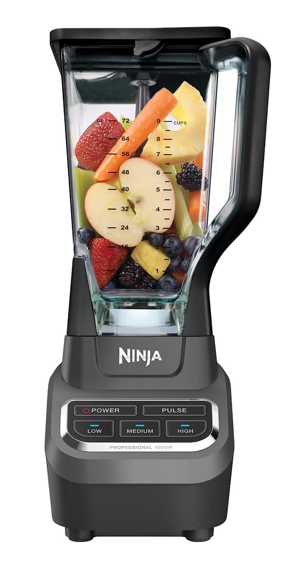 Blender filled with various fruits displaying measurement markings and buttons on the base for different blending options