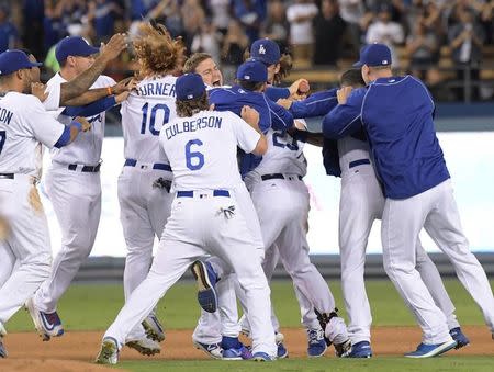 Sep 19, 2016; Los Angeles, CA, USA; Los Angeles Dodgers first baseman Adrian Gonzalez (23) celebrates with teammates after hitting a walk-off double in the ninth inning in a 2-1 victory over the San Francisco Giants during a MLB game at Dodger Stadium. Mandatory Credit: Kirby Lee-USA TODAY Sports