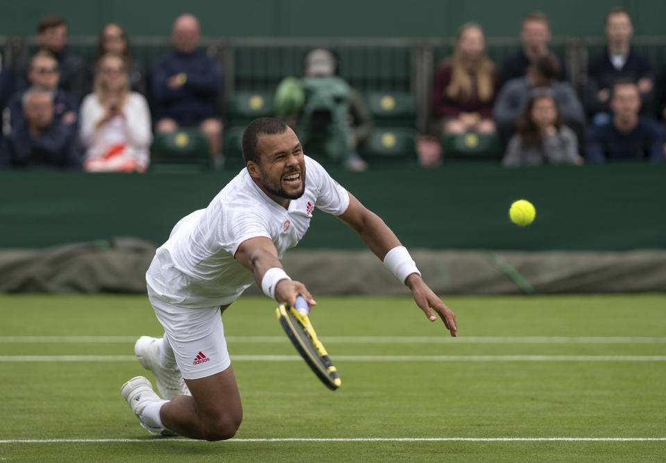 Jo-Wilfried Tsonga of France reaches for a volley as he plays against Sweden's Mikael Ymer during the men's singles first round match on day three of the Wimbledon Tennis Championships in London, Wednesday June 30, 2021. (Jed Leicester/Pool via AP)