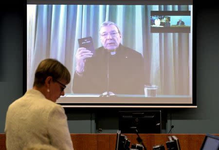 Senior Counsel Assisting Gail Furness stands in front of a screen displaying Australian Cardinal George Pell as he holds a bible while appearing via video link from a hotel in Rome, Italy to testify at the Australia's Royal Commission into Institutional Response to Child Sexual Abuse in Sydney, Australia, February 29, 2016. REUTERS/Jeremy Piper-Oculi/Handout via Reuters