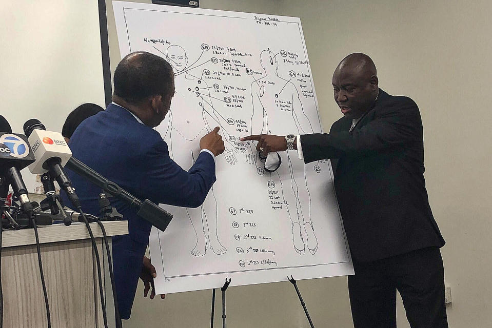 Attorneys Carl Douglas, left, and Benjamin Crump, right, point to bullet wounds on a diagram of Dijon Kizzee's body as part of an independent autopsy during a news conference in Los Angeles on Tuesday, Sept. 22, 2020. Dijon Kizzee, 29, "posed no threat" to deputies when they fired 19 shots at him, attorney Crump said at the news conference. Kizzee shot and killed by Los Angeles County sheriff's deputies wasn't holding a gun when they opened fire, attorneys for his family said Tuesday, contradicting a claim that he had picked up a dropped weapon during a struggle. (AP Photo/Stefanie Dazio)