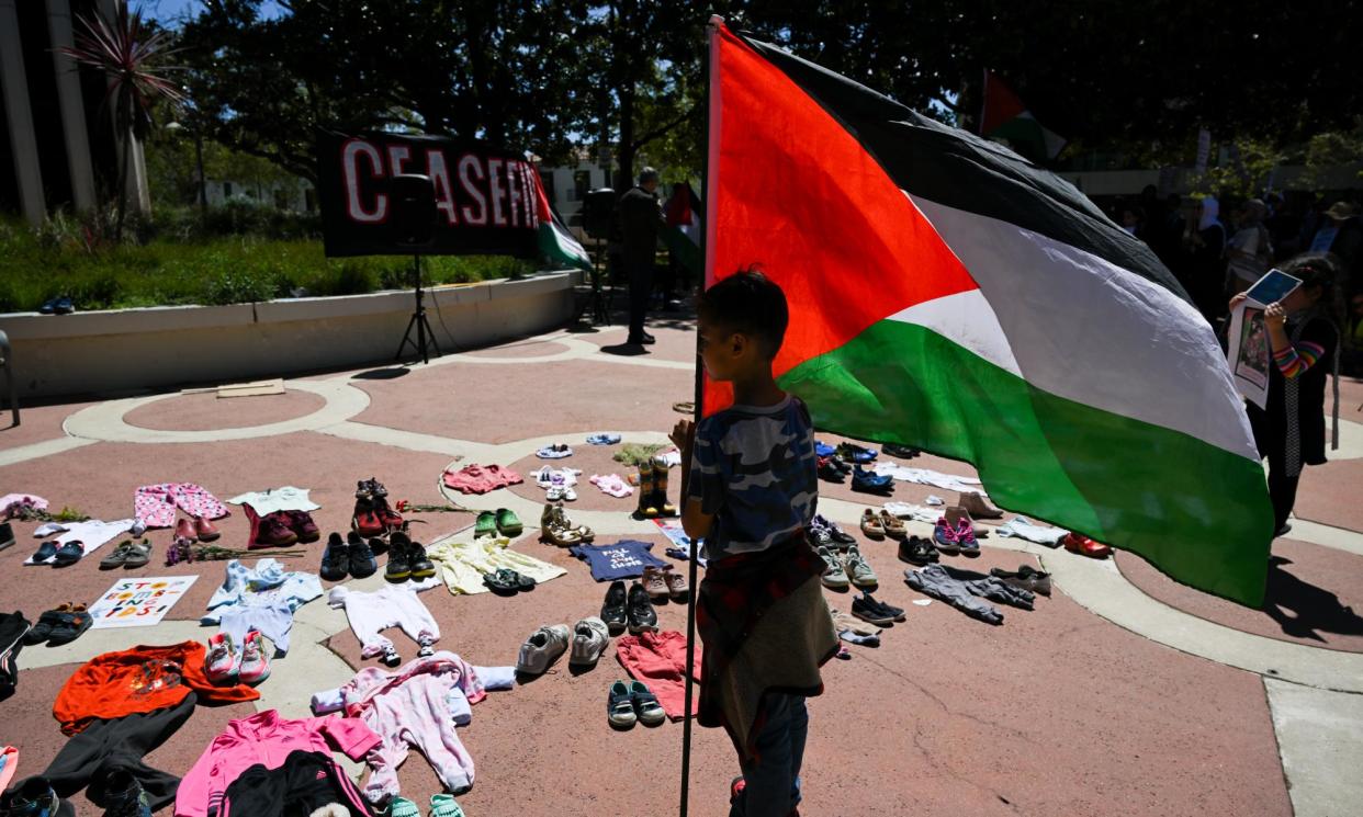 <span>Shoes and children’s clothes form part of a pro-Palestinian protest outside the city hall in Palo Alto, California, against Google's Project Nimbus on Sunday.</span><span>Photograph: Anadolu/Getty Images</span>