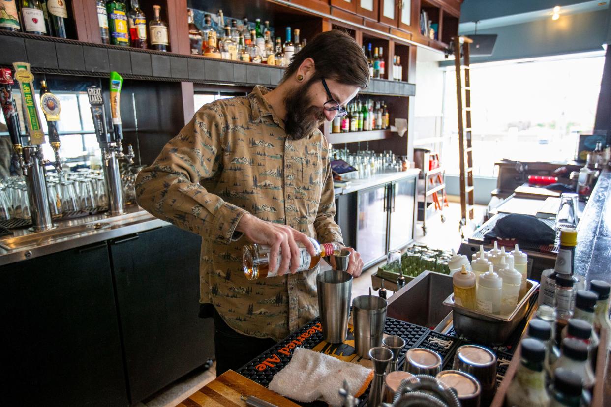 Mike Maike pours zero-alcohol whiskey while making a drink Wednesday, May 4, 2022, at Fatbird in South Bend.