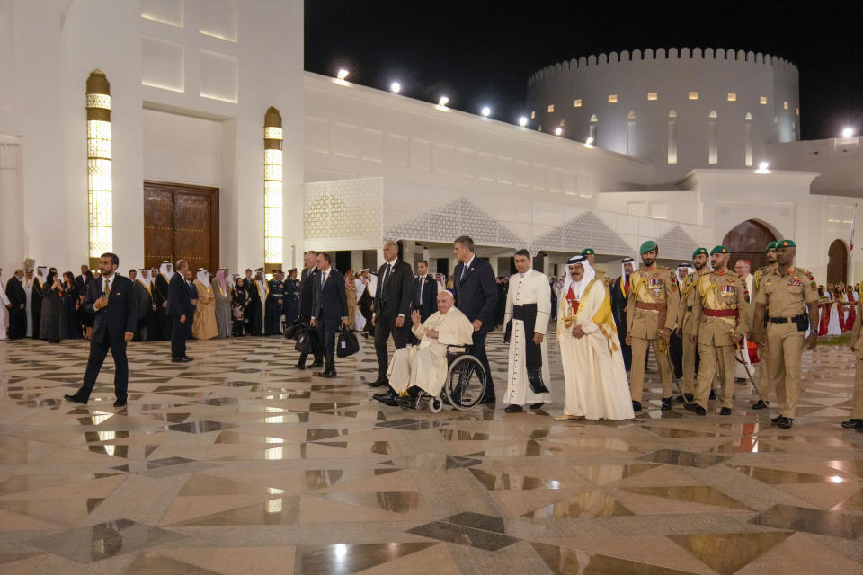Pope Francis talks with Bahrain's King Hamad bin Isa Al Khalifa as he leaves the Sakhir Royal Palace, Bahrain, Thursday, Nov. 3, 2022. Pope Francis is making the November 3-6 visit to participate in a government-sponsored conference on East-West dialogue and to minister to Bahrain's tiny Catholic community, part of his effort to pursue dialogue with the Muslim world. (AP Photo/Alessandra Tarantino)