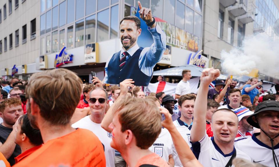 <span>An England supporter with a cardboard cutout of Gareth Southgate in Dortmund – but the manager is no longer universally popular with fans.</span><span>Photograph: Markus Schreiber/AP</span>