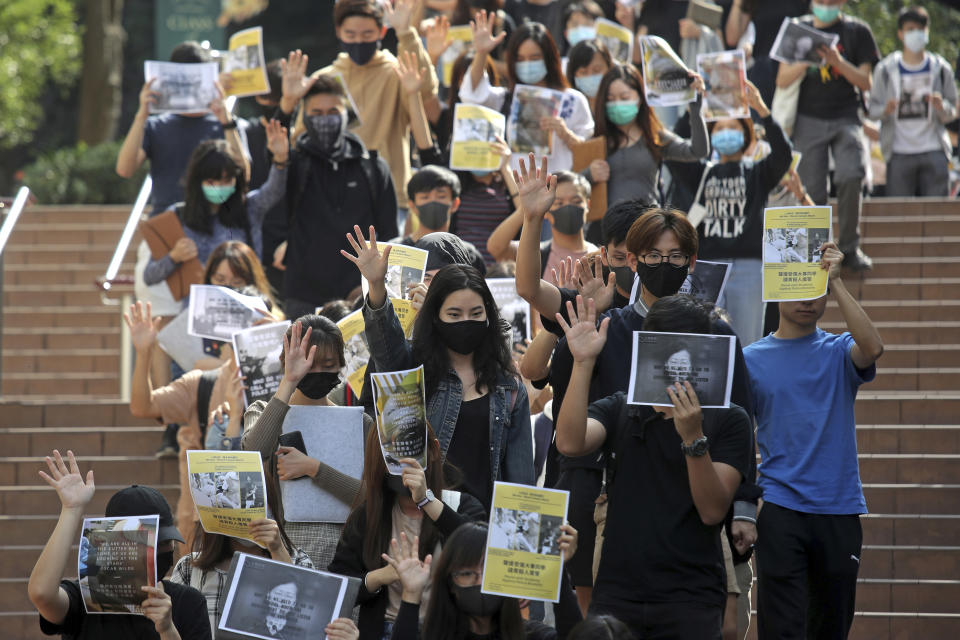 University students hold up their hands to represent the protesters' five demands at the campus of the University of Hong Kong, Wednesday, Nov. 6, 2019, as they protest against police brutality. Hong Kong police say an anti-government supporter stabbed and wounded a pro-Beijing Hong Kong lawmaker who was campaigning for local elections Wednesday, marking another escalation in five months of protests. (AP Photo/Kin Cheung)