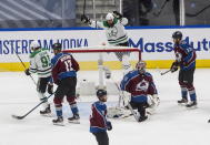 Colorado Avalanche goalie Philipp Grubauer (31) is scored against as Dallas Stars' Tyler Seguin (91) and Jamie Benn (14) celebrate during first-period NHL Western Conference Stanley Cup playoff hockey game action in Edmonton, Alberta, Saturday, Aug. 22, 2020. (Jason Franson/The Canadian Press via AP)