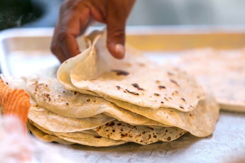 LOS ANGELES, CALIFORNIA - Jan. 11, 2020: Tortillera Julia Silva prepares fresh tortillas while working in El Ruso taqueria, which she co-owns with taquero Walter Soto, on Saturday, Jan. 11, 2020, at the outdoor El Ruso trailer in an industrial part of Boyle Heights, in Los Angeles. (Silvia Razgova / For the Times) Assignment ID: 477420