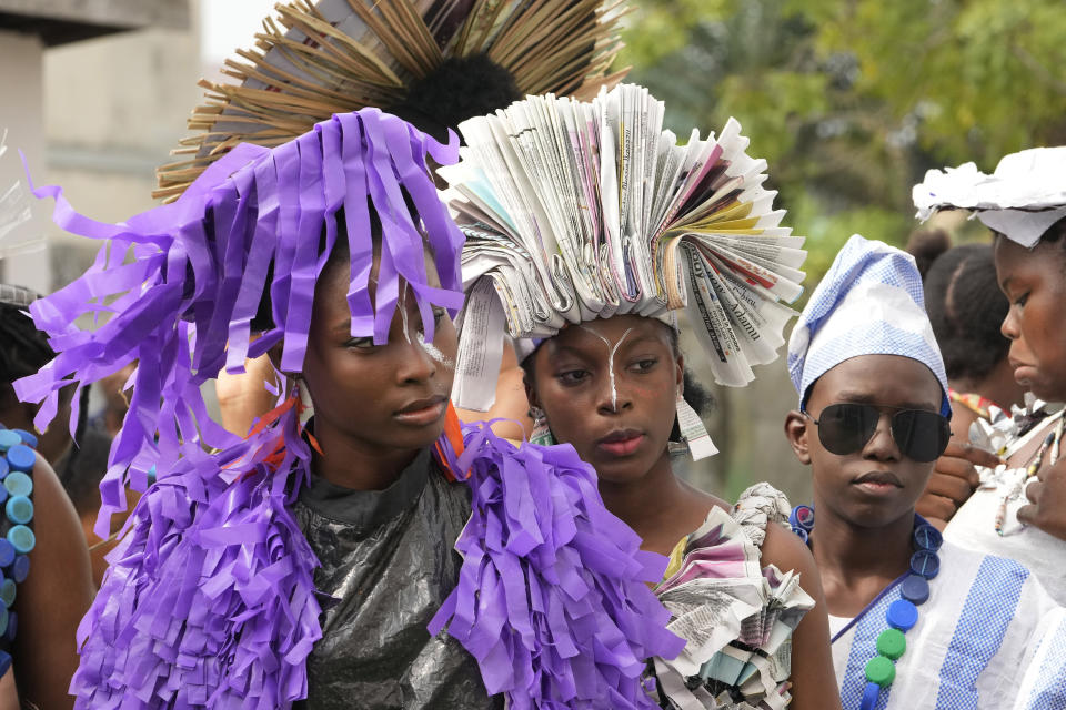 Models wearing outfits made from various recycled material wait back stage before a 'trashion show' in Sangotedo Lagos, Nigeria, Saturday, Nov. 19, 2022. (AP Photo/Sunday Alamba).