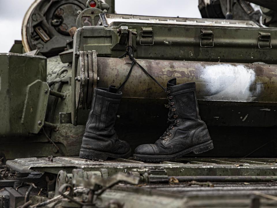 A damaged Russian military vehicle and military boots are seen after Russian Forces withdrawal as Russia-Ukraine war continues in Izium, Kharkiv Oblast, Ukraine on September 14, 2022.