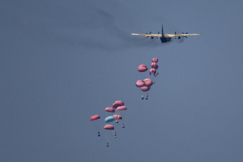 An aircraft airdrops humanitarian aid over northern Gaza Strip, as seen from southern Israel, Wednesday, March 20, 2024. (AP Photo/Leo Correa)