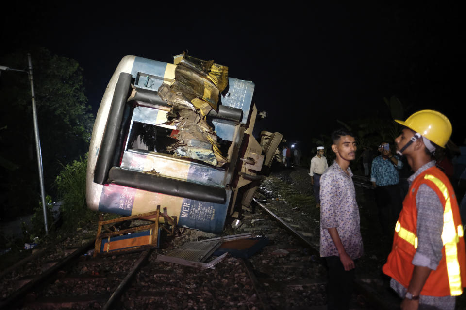 Rescuers work at the accident site where a cargo train has hit a passenger train at Bhairab, Kishoreganj district, Bangladesh, Monday, Oct. 23, 2023, leaving more than dozen people dead and scores injured. (AP Photo/Mahmud Hossain Opu)