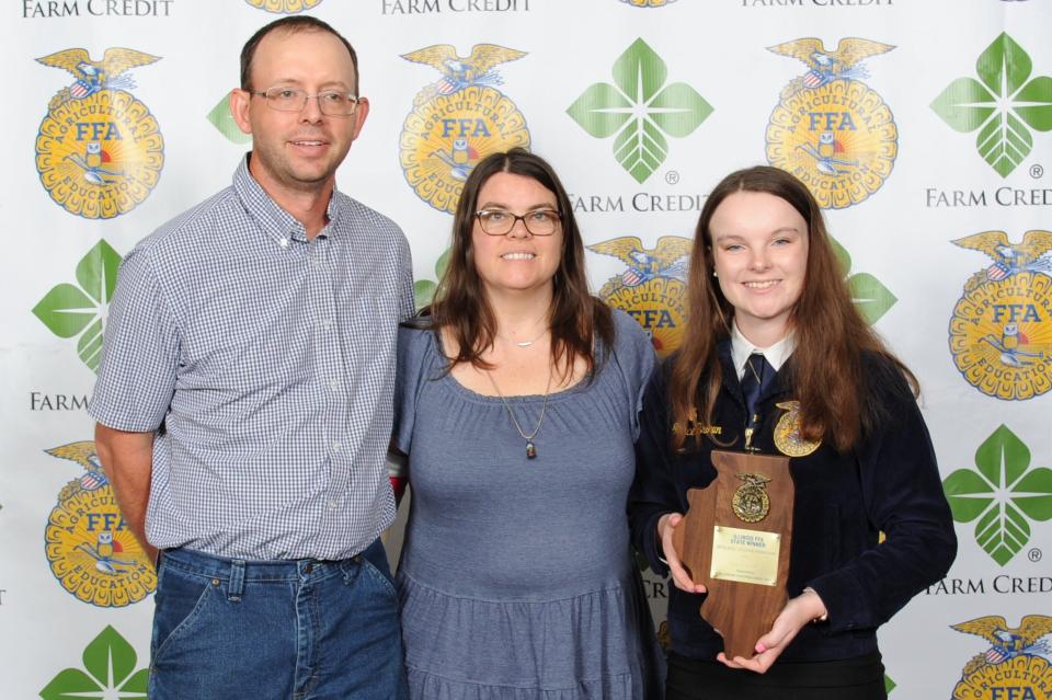 Grace Brown, right, with parents Jim and Christine Brown, as selected as the State FFA Proficiency winner in Diversified Livestock Production at the 94th annual Illinois State FFA Convention