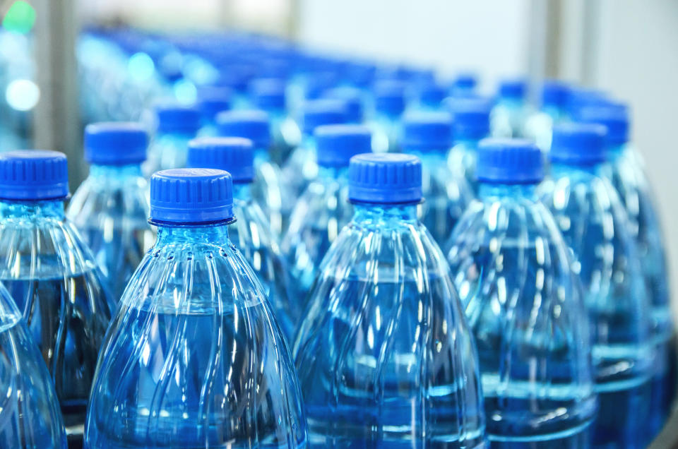 Closeup on mineral water green bottles in raw and lines