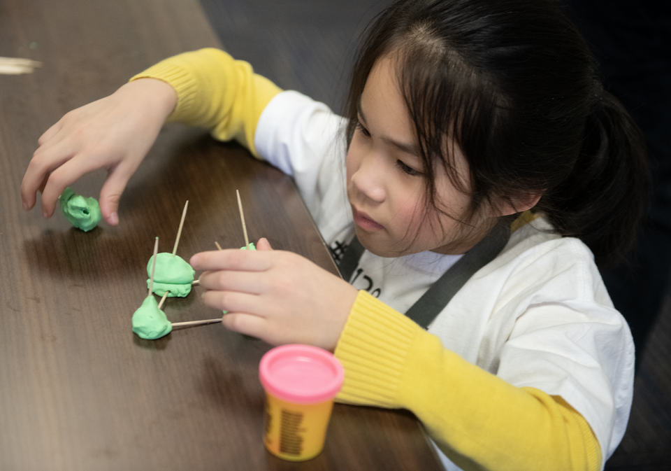 Bella Wang, 6, of Aurora, builds a space station structure out of play dough and toothpicks.