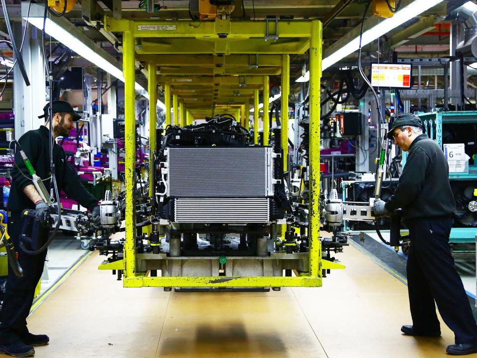 A Mini engine is 'dressed' on the assembly line at the BMW Mini car production plant in Oxford: Getty