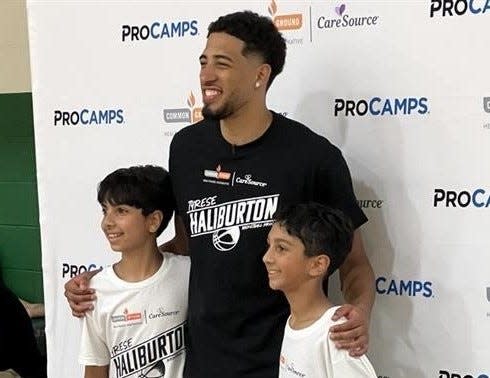 Tyrese Haliburton smiles for photos with youth Aug. 28, 2024, during the Tyrese Haliburton ProCamp in Oshkosh.