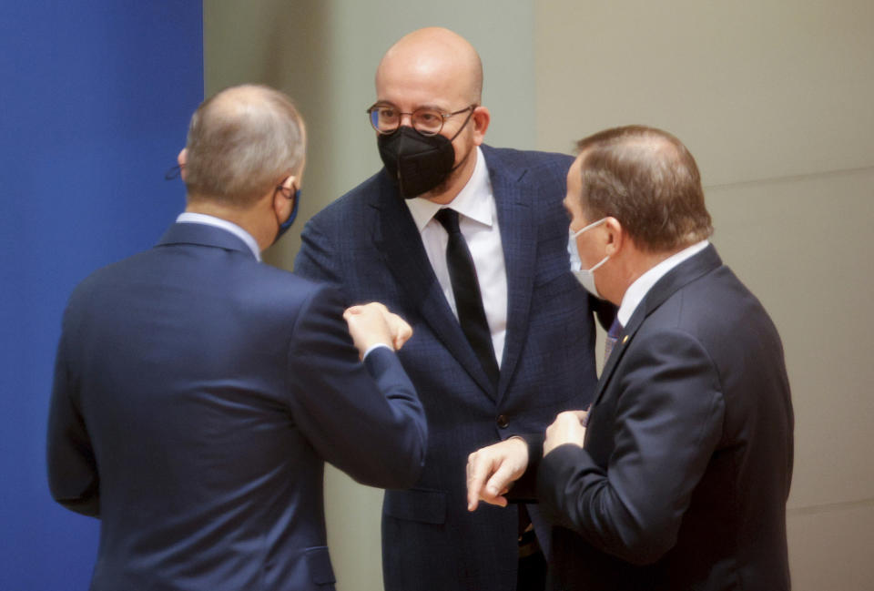 European Council President Charles Michel, center, speaks with Sweden's Prime Minister Stefan Lofven, right, during a round table meeting at an EU summit in Brussels, Friday, Oct. 22, 2021. European Union leaders conclude a two-day summit on Friday in which they discussed issues such as climate change, the energy crisis, COVID-19 developments and migration.(AP Photo/Olivier Matthys, Pool)