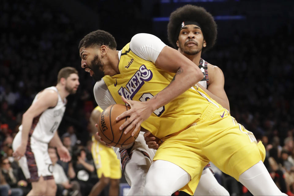 Los Angeles Lakers' Anthony Davis (3) spins past Brooklyn Nets' Jarrett Allen during the first half of an NBA basketball game Thursday, Jan. 23, 2020, in New York. (AP Photo/Frank Franklin II)