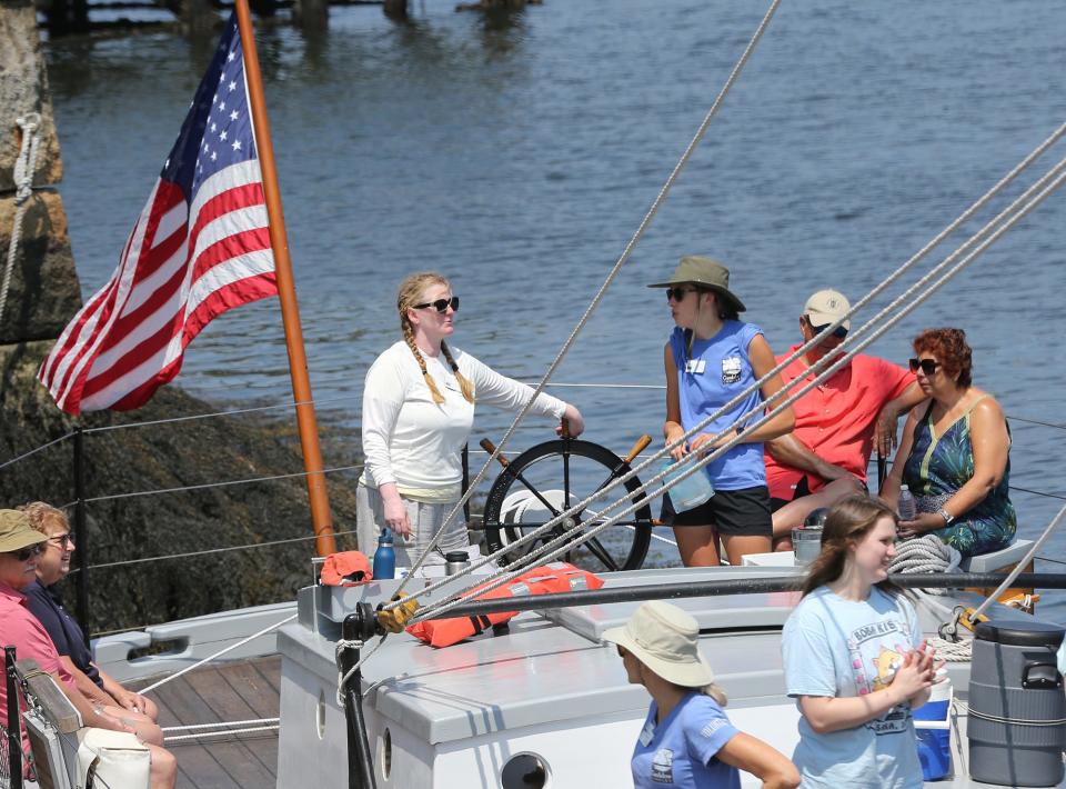 A captain of the Gundalow Company takes the helm and heads out from being docked at Prescott Park in 2023.