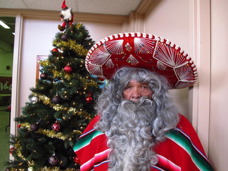 In this Wednesday, Dec. 18, 2013, photo, Julian Perez stands in his Pancho Claus suit in Lubbock, Texas. The retired 71-year-old has donned the Pancho Claus suit for 30 years to hand out gifts for low-income and at-risk children. (AP Photo/Betsy Blaney)