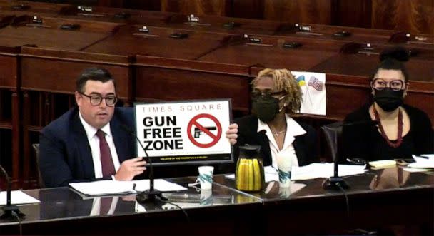 PHOTO: Robert Barrows, Executive Director, NYPD Legal Operations and Projects holds up a sign that will be displayed in Times Square while speaking at a City Council meeting on Aug. 29, 2022 in New York City. (Courtesy of New York City Council)