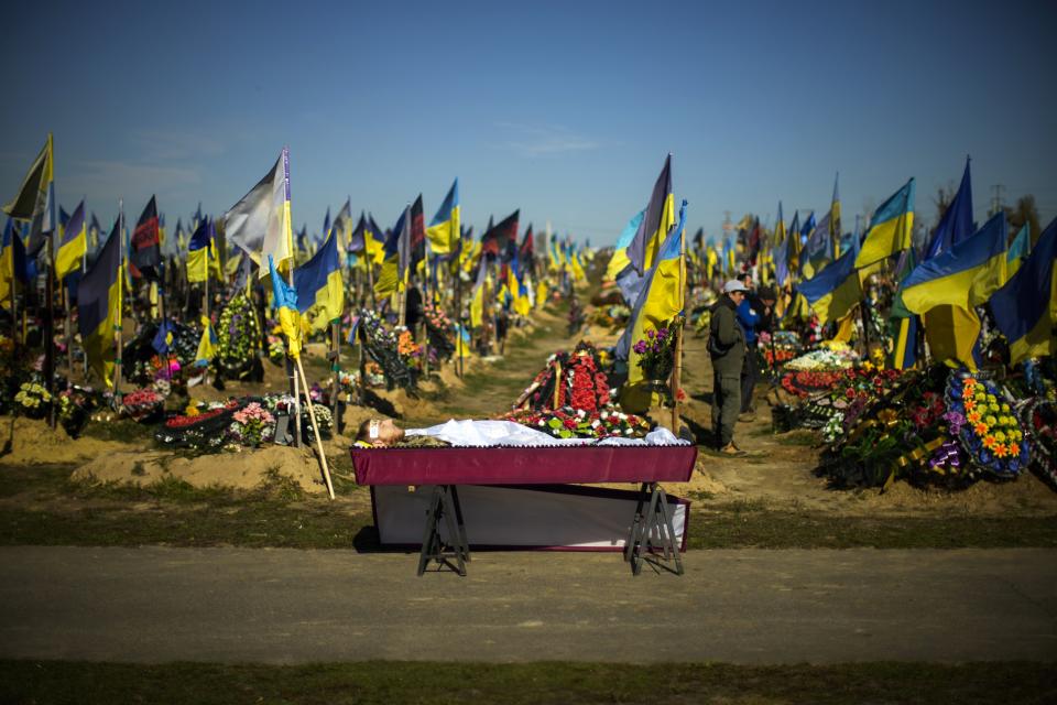 FILE - The body of Ukrainian serviceman Vadim Bereghnuy, 22, rests in a coffin during his funeral in Kharkiv, Ukraine, on Oct. 17, 2022. Some experts warn that the Ukraine war, which has already killed tens of thousands on both sides and reduced entire cities to ruins could drag on for years. (AP Photo/Francisco Seco, File)