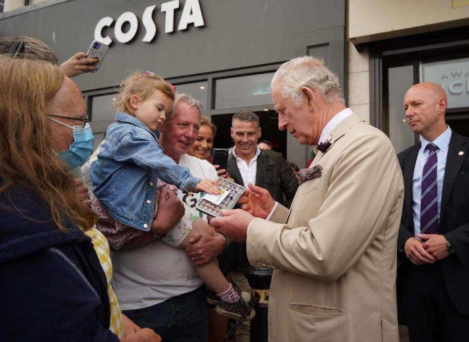 The Prince of Wales receives a box of flies for flyfishing from Robert Glennon and Elizabeth Williams (Peter Byrne/PA) (PA Wire)