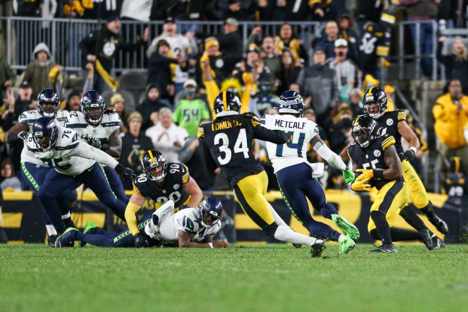 Pittsburgh Steelers inside linebacker Devin Bush (55) returns the ball after a fumble by Seattle Seahawks quarterback Geno Smith (7) in overtime. The Seattle Seahawks played the Pittsburgh Steelers at Heinz Field in Pittsburgh, Pa., on Sunday, Oct. 17, 2021.
