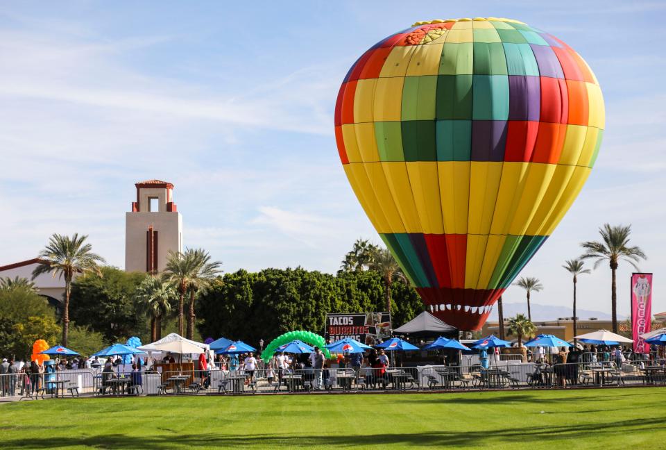 The Vero Beach Balloon Festival is Feb. 5-6 at the Indian River County Fairgrounds & Expo Center. In this Nov. 20, 2021, photo, a hot air balloon tethered for festival goers to take rides is seen in Cathedral City, California.