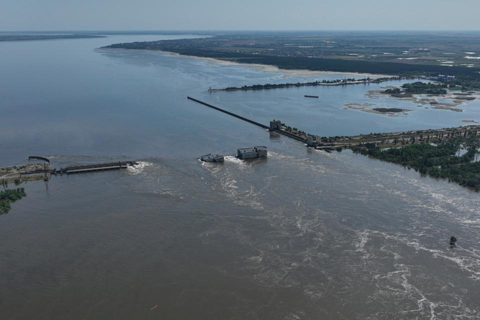Water flows over the collapsed Kakhovka Dam in Nova Kakhovka (Copyright 2023 The Associated Press. All rights reserved.)