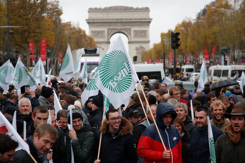 French farmers block the Champs Elysees avenue during a day of protest in Paris