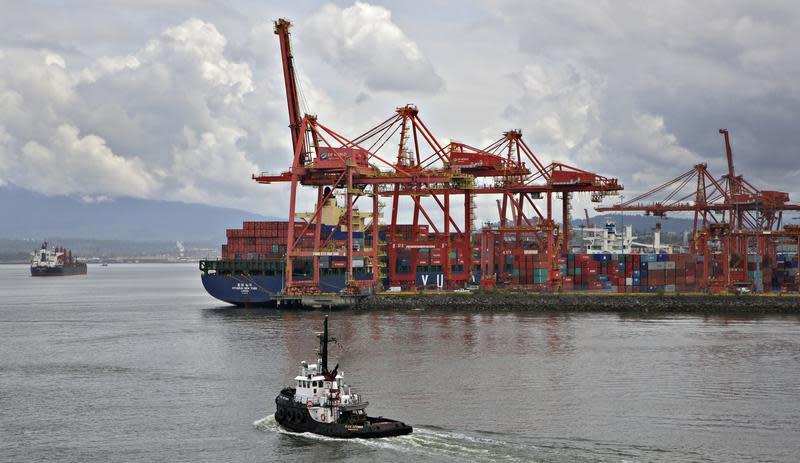 A tugboat heads out into the harbour beside the container port in Vancouver, British Columbia June 8, 2012. REUTERS/Andy Clark