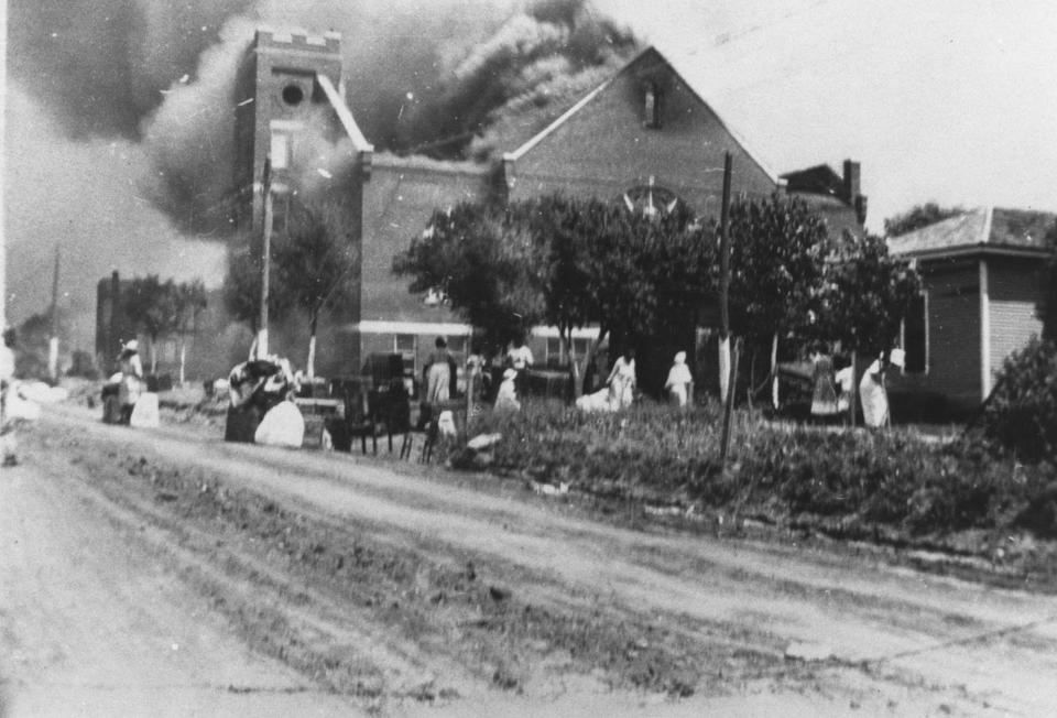 In this photo provided by the Department of Special Collections, McFarlin Library, The University of Tulsa, the Mt. Zion Baptist Church burns in Tulsa, Okla. during the Tulsa Race Massacre of June 1, 1921. (Department of Special Collections, McFarlin Library, The University of Tulsa via AP)