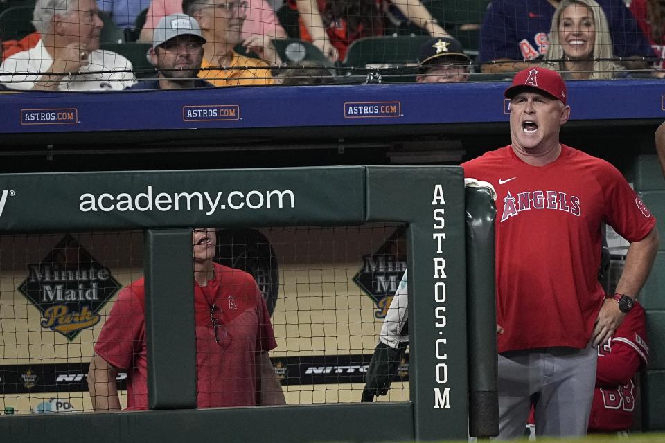 Los Angeles Angels manager Phil Nevin yells at home plate umpire Stu Scheurwater after a strike-three call during the sixth inning of a baseball game against the Houston Astros Thursday, June 1, 2023, in Houston. Nevin was ejected from the game. (AP Photo/David J. Phillip)