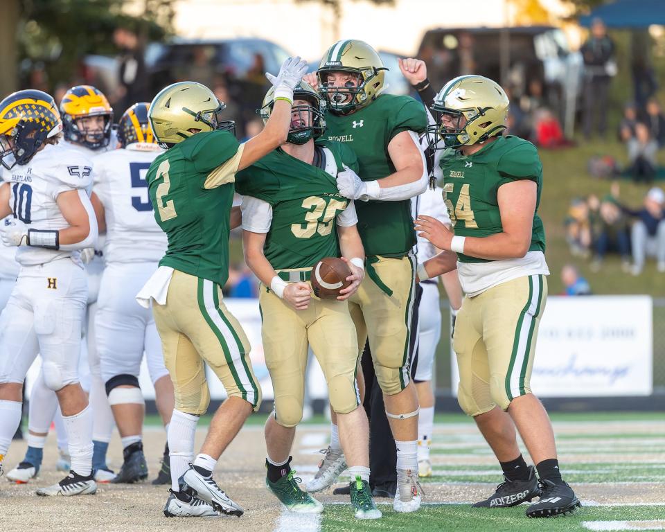 Howell quarterback Justin Jones (35) is congratulated after scoring the first touchdown in a 33-13 loss to Hartland on Friday, Sept. 30, 2022.