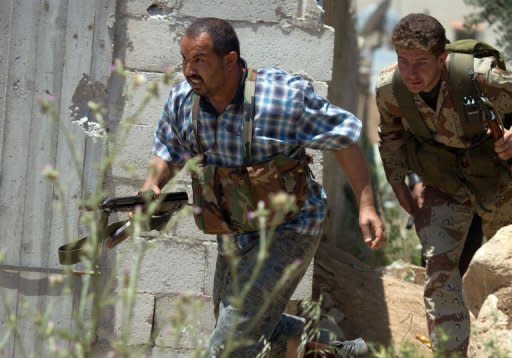 Members of the Free Syrian Army's "Freedom for the River Assi Brigade" run as they take part in an attack on Syrian regime forces in Homs province. Syrian troops stormed a village in central Syria on Sunday and rained shells on rebel strongholds Douma and Rastan, monitors said, as a UN-backed truce entered a second month looking in tatters