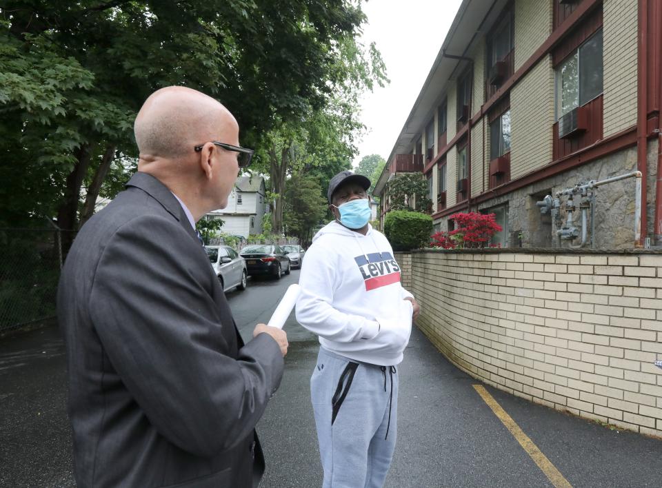 Rockland Office of Codes Director Ed Makunas talks with resident Yvon Bertrand at 17 Ridge Ave., in Spring Valley May 19, 2022. The apartment building has been declared unsafe because of violations of fire and safety codes.